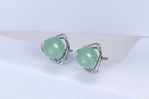 Macro detail of S925 silver triangle frame earrings with green round aventurine beads
