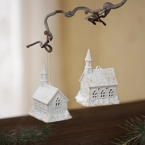 White church Christmas ornaments with gold glitter finish on rustic wooden branch