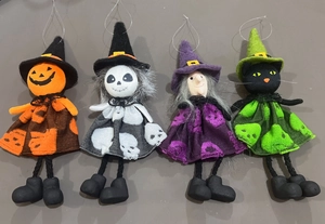 Detailed view of four Halloween hanging dolls featuring pumpkin, skull, witch and cat