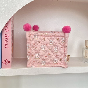 Detailed view of pink quilted fabric storage basket with cute bunny and pom-poms
