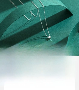Macro shot of silver star pendant necklace showing handmade mirror polish and fine chain
