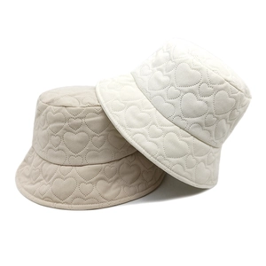 Winter corduroy bucket hat with heart quilted pattern in beige and off-white colors