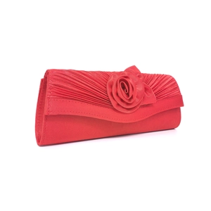 Macro detail of red satin evening clutch with handmade rose flower and pleated fabric