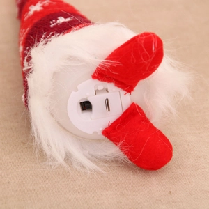 Detail of battery compartment and power switch on the base of glowing Christmas plush toy