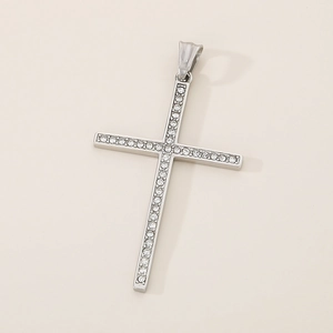 Detailed close-up of a silver cross pendant featuring fully inlaid shimmering white crystals