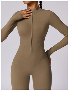 Detail of front zipper and stand collar on a high-stretch yoga jumpsuit in olive green