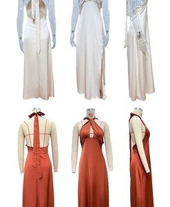 Detail view of satin halter dress with high slit and open back in cream and rust colors