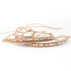 Close-up of handmade bohemian woven cord with colorful beads and ethnic pattern details