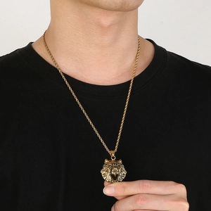 Close-up of a men's gold lion head pendant necklace with twist rope chain on a model