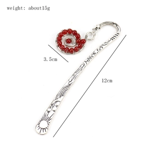 Detailed view of vintage silver metal bookmark with red bead and size dimensions
