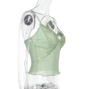 Detail of mint green lace camisole showing V-neck trim and sheer mesh fabric textures