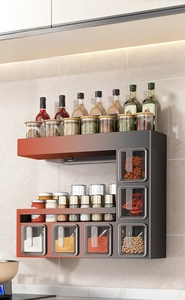 Detail of wall-mounted kitchen spice rack showing multi-tier storage and spice boxes