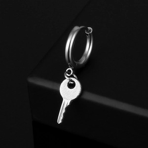 Macro shot of silver stainless steel hoop earring with a detailed key-shaped pendant detail