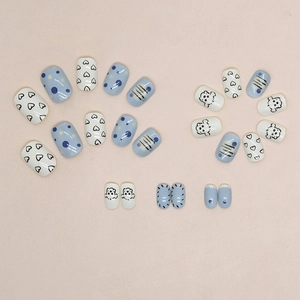 Cute sky blue and white press-on nails with puppy, heart, and polka dot designs