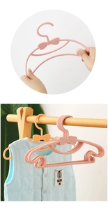 Close-up of pink bow kids hanger showing high flexibility and non-slip baby vest storage
