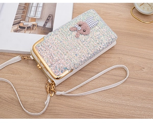 Detail view of a white crossbody bag with shiny sequins and a cute bunny design