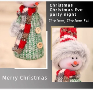 Detail of Christmas snowman ornament with green knit fabric and wooden buttons