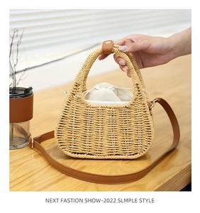 Detail view of handmade woven straw bag with leather strap and drawstring inner pocket