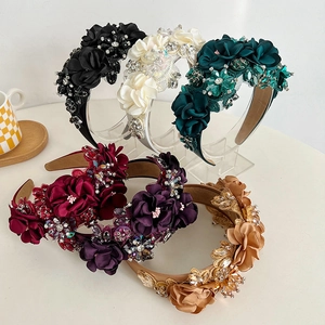 Detail of handcrafted rhinestone floral headbands in multiple vibrant silk colors