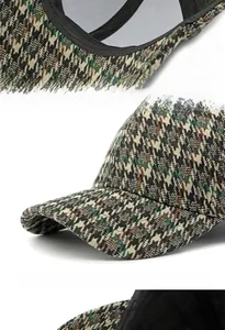 Detail view of houndstooth baseball cap with reinforced brim and lining texture