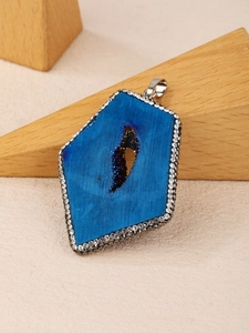 Detail shot of a natural druzy agate pendant with sparkling zircon border and silver bail