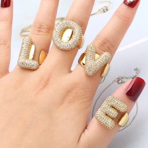 Gold plated alphabet rings set with micro-paved zircons forming the word LOVE