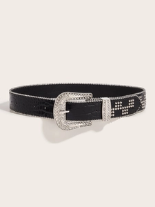 Detail of black faux crocodile leather belt with sparkling rhinestones and metal rivets