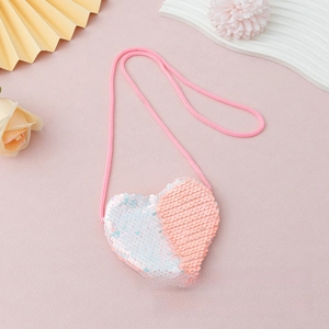 Detail of pink and white reversible sequin heart-shaped mini crossbody bag for kids