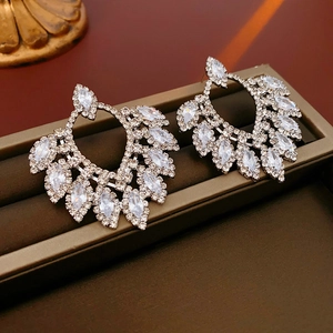 Macro shot of silver drop earrings with marquise-cut cubic zirconia on a jewelry box
