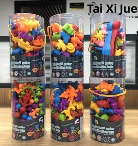 Vertical stack of six colorful sorting toy jars with tweezers for early learning