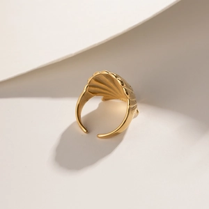 Detailed view of the 18K gold plated seashell texture on an adjustable open ring band
