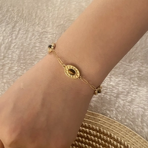 Detail of double-layer gold tiger eye stone bracelet on wrist with elegant vintage style
