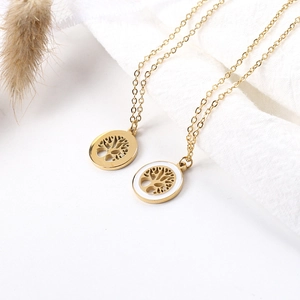 Close-up of gold tree of life necklaces with classic cutout and white enamel frame