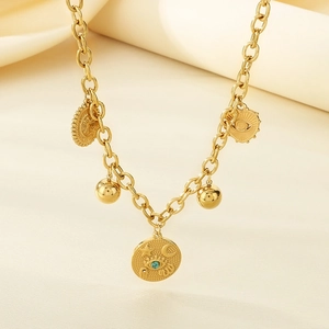 Macro detail of gold stainless steel necklace with turquoise evil eye and star moon pendant