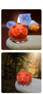 Macro view of cartoon tiger candle mold with fine embossed textures and orange finish