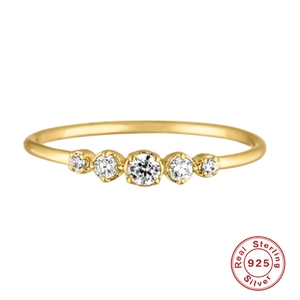 Close-up of golden S925 sterling silver V-shape ring with five sparkling opal gemstones