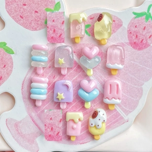 Close-up of assorted resin popsicle charms for DIY nails and jewelry in pastel colors