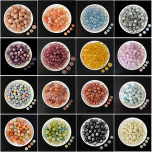 Macro display of 14K gold-plated strawberry quartz beads in sixteen vibrant colors