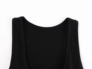 Detailed macro view of the black ribbed knit neckline and reinforced shoulder stitching