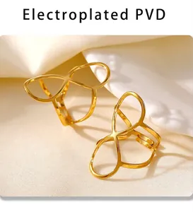 Detailed macro of gold PVD plated stainless steel infinity ring on a soft fabric texture