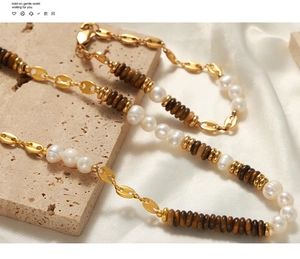 Detail of necklace with gold coffee bean links, freshwater pearls and tiger eye beads