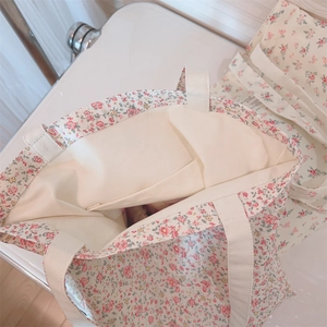 Detail view of floral cotton tote interior featuring a convenient open storage pocket