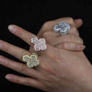 Detailed view of hip hop cross ring with sparkling zircons and layered gold finish