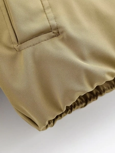 Détail du tissu sergé kaki avec coutures sur les poches et poignets élastiqués serrés