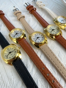 Various leather strap women's quartz watches with gold cases in a professional diagonal layout