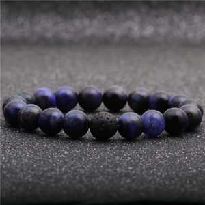 Macro shot of 8mm tiger eye and lava stone beads on a flexible beaded bracelet
