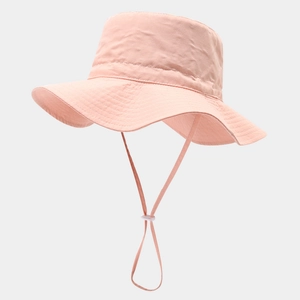 Close-up of pink-orange sun hat featuring windproof strap and adjustable buckle detail