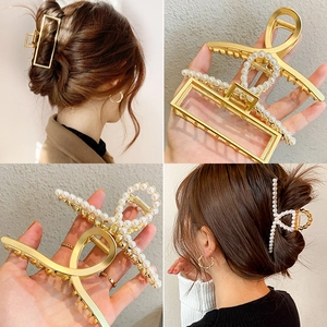 Golden metal hair claw clips with pearls and geometric design for women's hairstyling