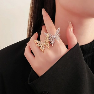Macro detail of a butterfly ring with gold plating, sparkling zircons, and white pearls