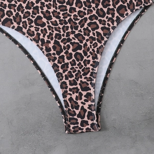 Detailed macro view of leopard print swimwear fabric with high-quality elastic stitching